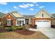 Charming one-story home with brick and siding exterior, landscaped yard, and attached two-car garage at 7203 Shenandoah Dr, Fort Mill, SC 29707