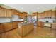 Spacious kitchen featuring wood cabinetry, granite counters, and a central island at 7203 Shenandoah Dr, Fort Mill, SC 29707