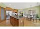 Bright kitchen featuring an island, stainless refrigerator, and an adjacent breakfast nook at 7203 Shenandoah Dr, Fort Mill, SC 29707