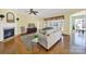 Cozy living room with a fireplace, ceiling fan, hardwood floors and views to other rooms at 7203 Shenandoah Dr, Fort Mill, SC 29707