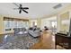 Bright living room with hardwood floors, ceiling fan, a view to the dining room and lots of sunlight at 7203 Shenandoah Dr, Fort Mill, SC 29707