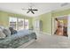 Spacious bedroom with three windows, a ceiling fan, and a seating area at 7203 Shenandoah Dr, Fort Mill, SC 29707