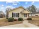 Single-story home featuring yellow siding, neat landscaping, and a welcoming front porch at 732 N Chestnut St, Gastonia, NC 28054