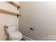 Powder room featuring a sleek toilet and wooden shelves for storage at 8008 Breckenhill Ln, Tega Cay, SC 29708