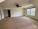 Bedroom with neutral walls, carpet, dual windows providing natural light, and a ceiling fan at 8471 Penton Pl, Harrisburg, NC 28075