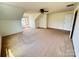 Bedroom with angled ceilings, carpet, and a ceiling fan featuring dual windows providing views and natural light at 8471 Penton Pl, Harrisburg, NC 28075