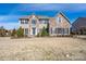 Charming two-story home featuring a stone and vinyl facade, black shutters, and a well-manicured front yard at 8471 Penton Pl, Harrisburg, NC 28075