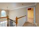 A hallway with wood railings, carpet, and a chandelier at 8471 Penton Pl, Harrisburg, NC 28075