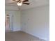 Comfortable main bedroom with a glimpse of an ensuite bathroom, carpet flooring, and white trim at 8471 Penton Pl, Harrisburg, NC 28075