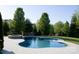 Backyard view of a large in-ground pool with concrete pavers at 8471 Penton Pl, Harrisburg, NC 28075