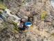 Aerial view of the home with a private pool surrounded by trees and lush landscaping at 1006 Lost Cv, Weddington, NC 28104