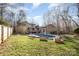 Lush backyard with well-manicured lawn and a sparkling in-ground swimming pool at 1006 Lost Cv, Weddington, NC 28104