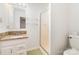 Bathroom featuring a granite vanity top, shower with glass doors, and a toilet at 1006 Lost Cv, Weddington, NC 28104
