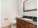 Half bath featuring dark wood cabinet, black granite top, and neutral paint at 1006 Lost Cv, Weddington, NC 28104