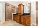 Bathroom with custom cabinets, granite counters, and walk-in shower at 1006 Lost Cv, Weddington, NC 28104
