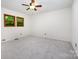 Bright bedroom featuring plush carpeting, ceiling fan, and natural light from a window at 1006 Lost Cv, Weddington, NC 28104