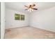 Bedroom featuring two windows, carpet flooring and ceiling fan at 1006 Lost Cv, Weddington, NC 28104