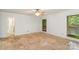 Bright bedroom featuring neutral paint, tile flooring, and two sun-filled windows at 1006 Lost Cv, Weddington, NC 28104
