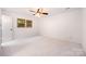 Bright bedroom features neutral walls, carpet, and a ceiling fan at 1006 Lost Cv, Weddington, NC 28104