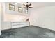 Loft featuring gray carpet, neutral paint, and built in bookshelves at 1006 Lost Cv, Weddington, NC 28104
