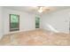 Spacious bedroom with tile floors, natural light, and ceiling fan at 1006 Lost Cv, Weddington, NC 28104