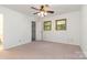 Bright bedroom with carpeted floor, ceiling fan, and natural light from two windows at 1006 Lost Cv, Weddington, NC 28104