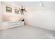 Bonus room featuring plush carpeting, ceiling fan, built-in shelves, and natural light at 1006 Lost Cv, Weddington, NC 28104
