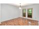 Dining room with hardwood floors, a hanging light fixture, and large windows at 1006 Lost Cv, Weddington, NC 28104