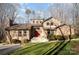 Charming home with a brick exterior, complemented by manicured landscaping and mature trees at 1006 Lost Cv, Weddington, NC 28104