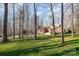 A home with mature trees, lawn, and long driveway create a scenic exterior at 1006 Lost Cv, Weddington, NC 28104