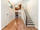 Bright foyer with wood floors, staircase, and view into a fireplace and built-ins at 1006 Lost Cv, Weddington, NC 28104