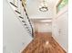 Entryway showcasing hardwood floors, staircase, and a chandelier at 1006 Lost Cv, Weddington, NC 28104