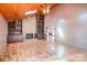 Inviting living room with wood ceiling, fan, fireplace, and built-in shelving at 1006 Lost Cv, Weddington, NC 28104