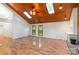Spacious living room with wood floors, wood ceiling, skylights and a view of the backyard at 1006 Lost Cv, Weddington, NC 28104