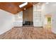 The living room features wood floors, a brick fireplace with built-in shelves and cabinets at 1006 Lost Cv, Weddington, NC 28104