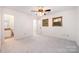 Main bedroom featuring plush carpeting, ceiling fan, and ensuite bathroom at 1006 Lost Cv, Weddington, NC 28104