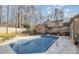 Inviting backyard pool with a well-maintained deck and mature trees adding privacy to the outdoor space at 1006 Lost Cv, Weddington, NC 28104