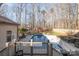 Backyard view of a fenced pool and deck in a wooded neighborhood at 1006 Lost Cv, Weddington, NC 28104