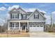 Charming two-story home featuring gray siding, stone accents, and a welcoming front porch at 1012 Thomas Knapp Pkwy, Fort Mill, SC 29715