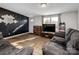 Cozy living room featuring stylish flooring, a comfortable sofa, and a large window for natural light at 108 S Inman Ave, Bessemer City, NC 28016