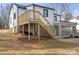 Exterior back of home featuring a walkout basement and sunroom addition at 1110 Alexander St, Statesville, NC 28677