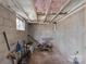 Unfinished basement with cement walls and exposed ceiling offering potential to be customized at 1110 Alexander St, Statesville, NC 28677