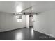 Bright basement area with painted brick, sealed floors, and a doorway leading to another room at 1110 Alexander St, Statesville, NC 28677