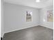 This bedroom has gray floors, neutral walls, and two windows at 1110 Alexander St, Statesville, NC 28677