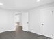 Bright bedroom with neutral walls, gray floors and white doors at 1110 Alexander St, Statesville, NC 28677