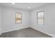 This bedroom has gray walls, white trim and two windows at 1110 Alexander St, Statesville, NC 28677