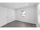 Neutral bedroom features two closets, gray floors and one window at 1110 Alexander St, Statesville, NC 28677