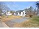 Well-maintained home with a gravel driveway and a cozy covered front porch at 1110 Alexander St, Statesville, NC 28677