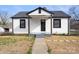Charming house with a classic black and white color scheme and a well-maintained front yard at 1110 Alexander St, Statesville, NC 28677