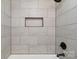 Updated shower with light gray tiling and recessed shelf at 1110 Alexander St, Statesville, NC 28677
